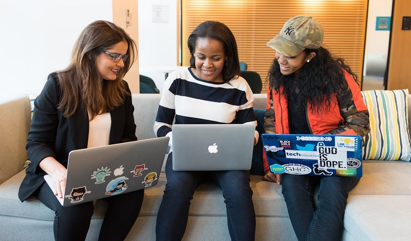 Three women using laptops